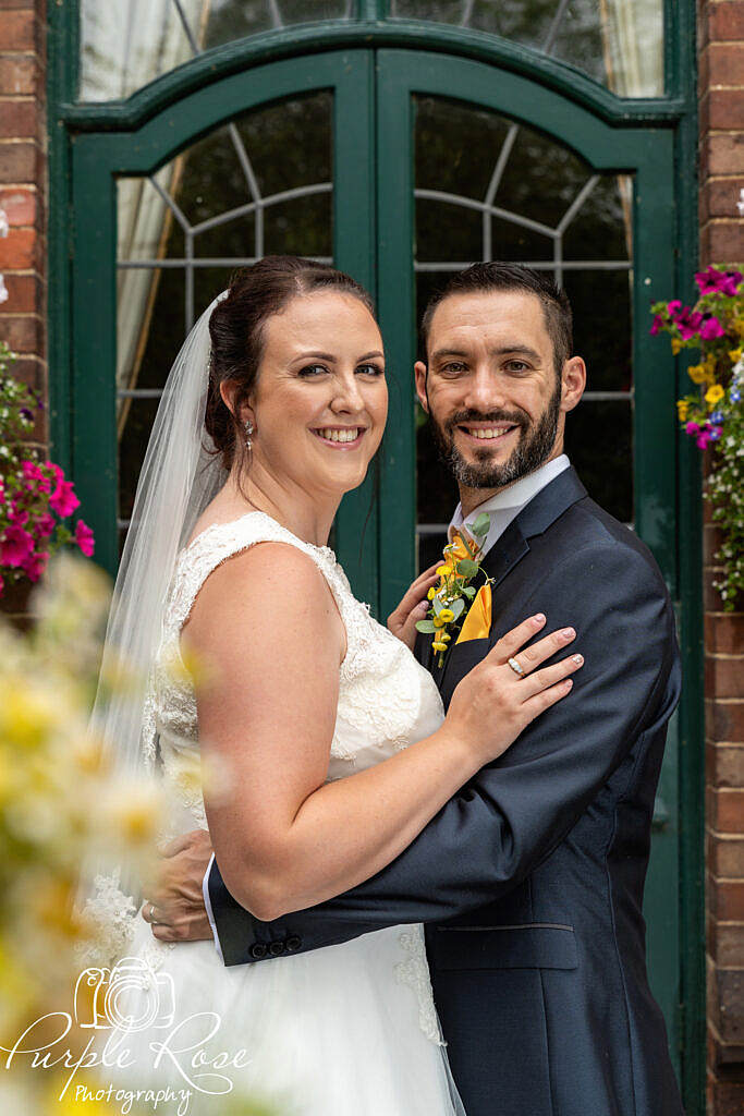 Bride and groom surrounded by flowers