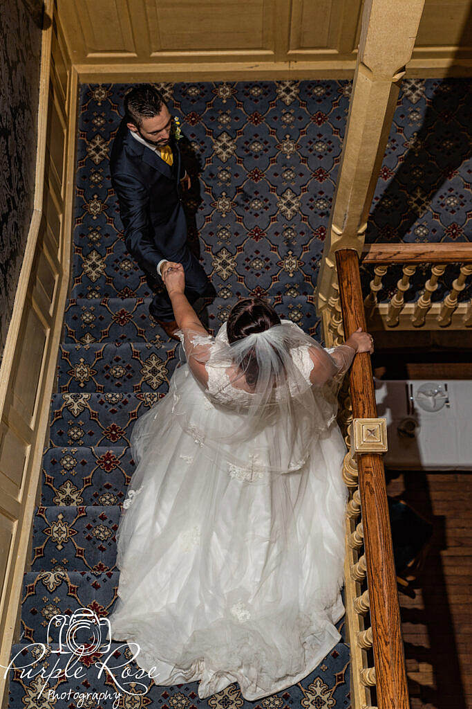 Bride and groom walking down a staircase