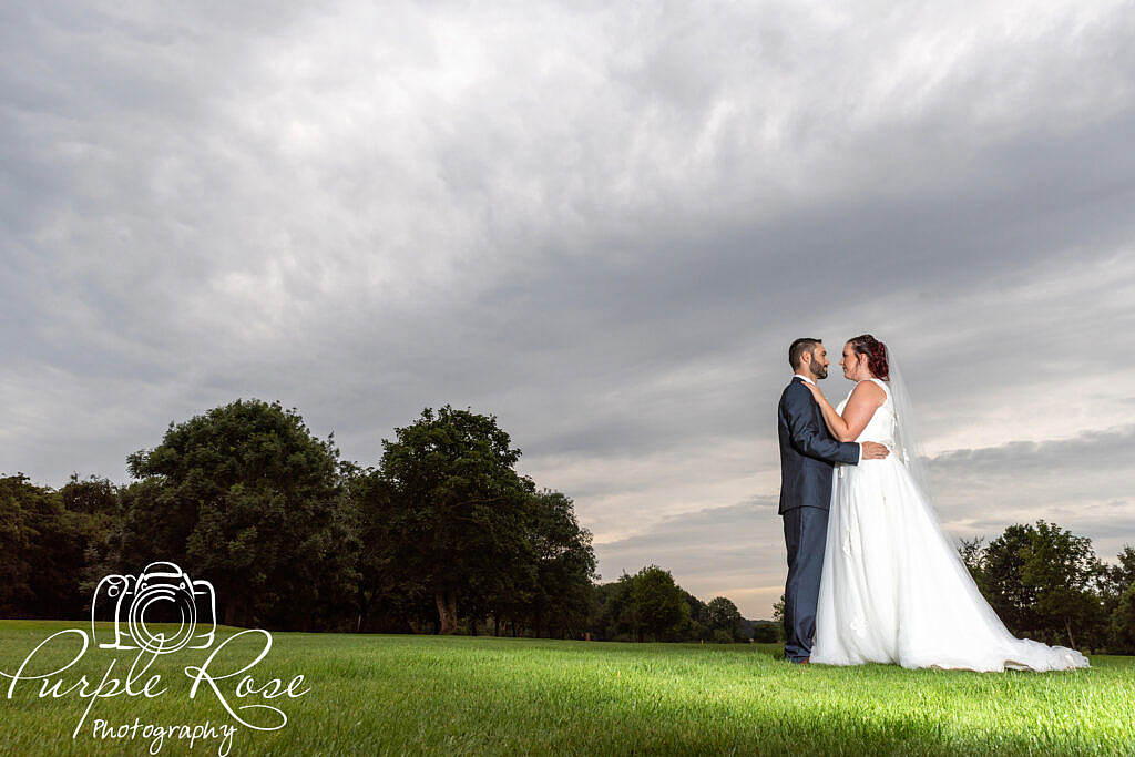 Bride and groom in front of a grey story sky