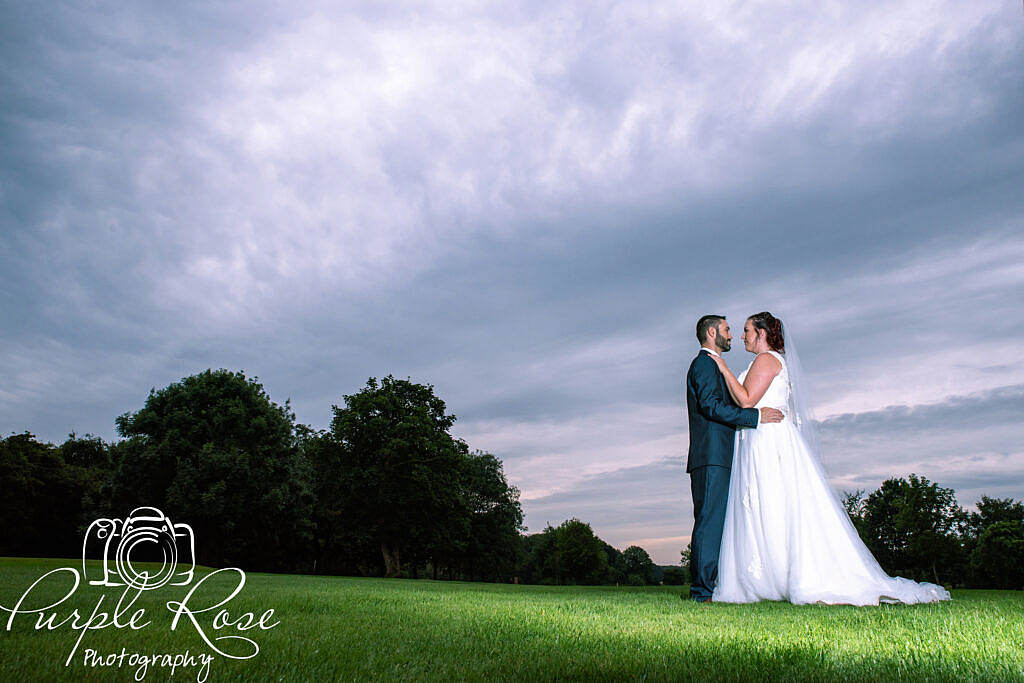 bride and groom in front of a dark stormy sky