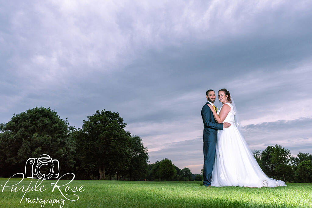 Bride and groom in front of a sunset