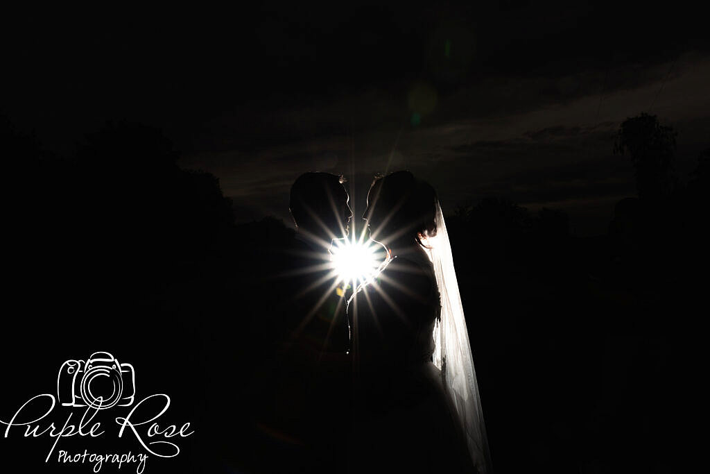 Night time silhouette of bride and groom