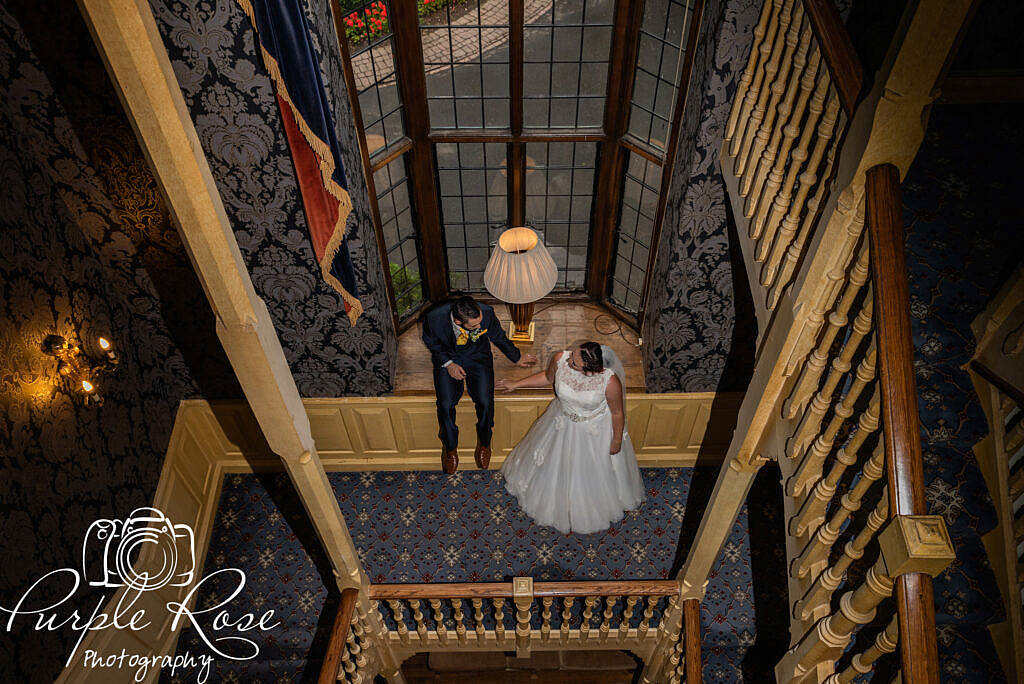 Bride and groom waiting on a staircase