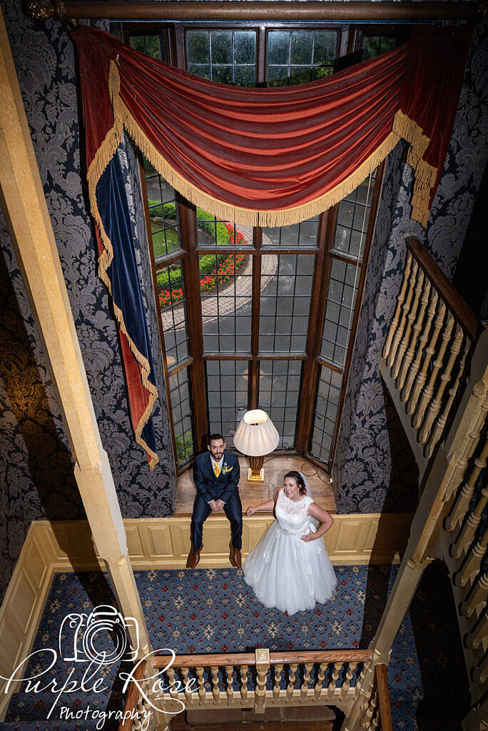 Bride and groom relaxing on a stair case