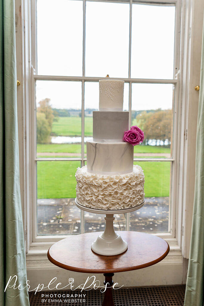 Wedding cake in a window at Kelmarsh Hall Northampton