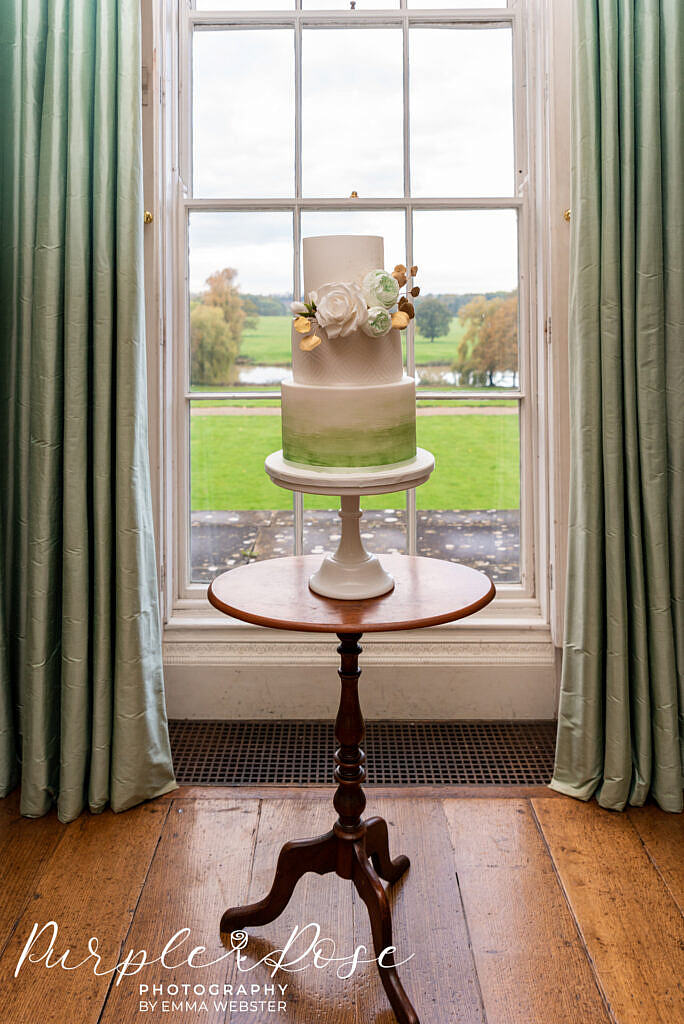 Green and white wedding cake in Kelmasrsh Hall Northampton