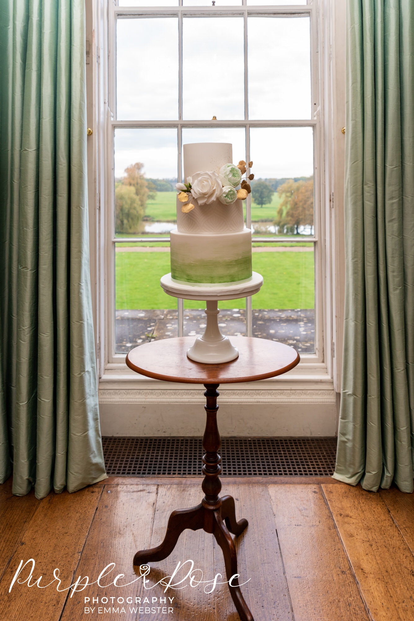 Green and white wedding cake in Kelmasrsh Hall Northampton