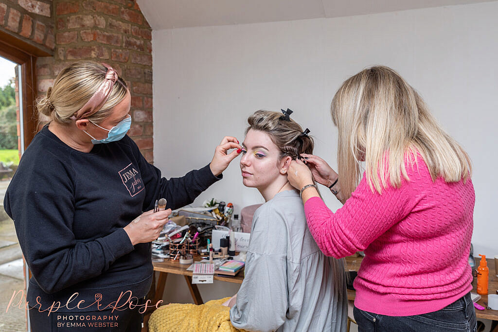 Bride having her hair and makeup applied