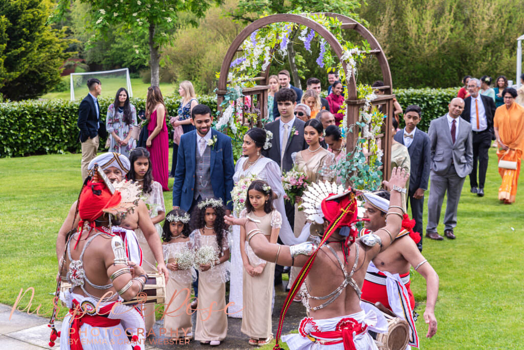 Photo of bride and grooms wedding procession leaving the wedding ceremony in Milton Keynes