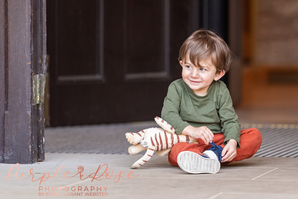 Boy sat in a doorway