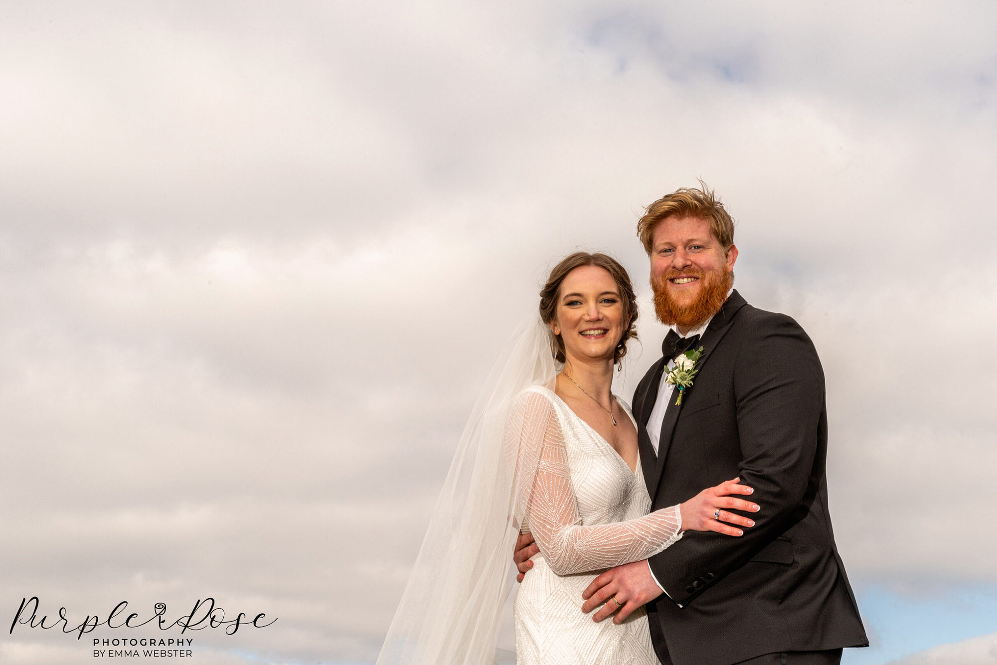 Photograph of a bride and groom on a cloudy day outside on their wedding day in Milton Keynes