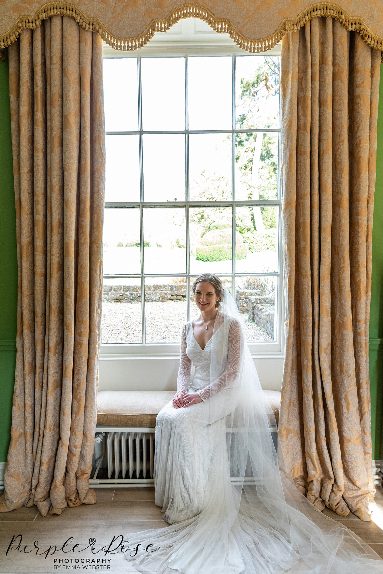 Photo of a bride sat by a window on her wedding day in Milton Keynes