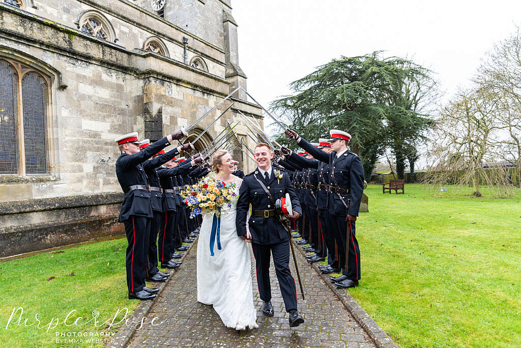 bride and groom walking under sword salute
