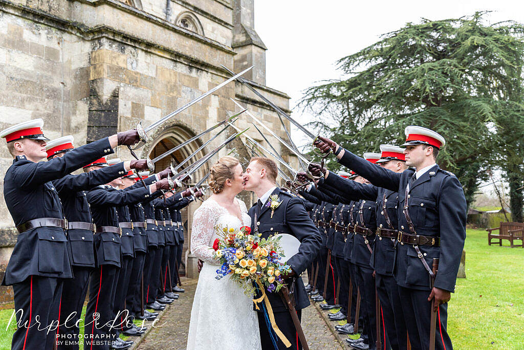 Bride and groom kissing at a military wedding