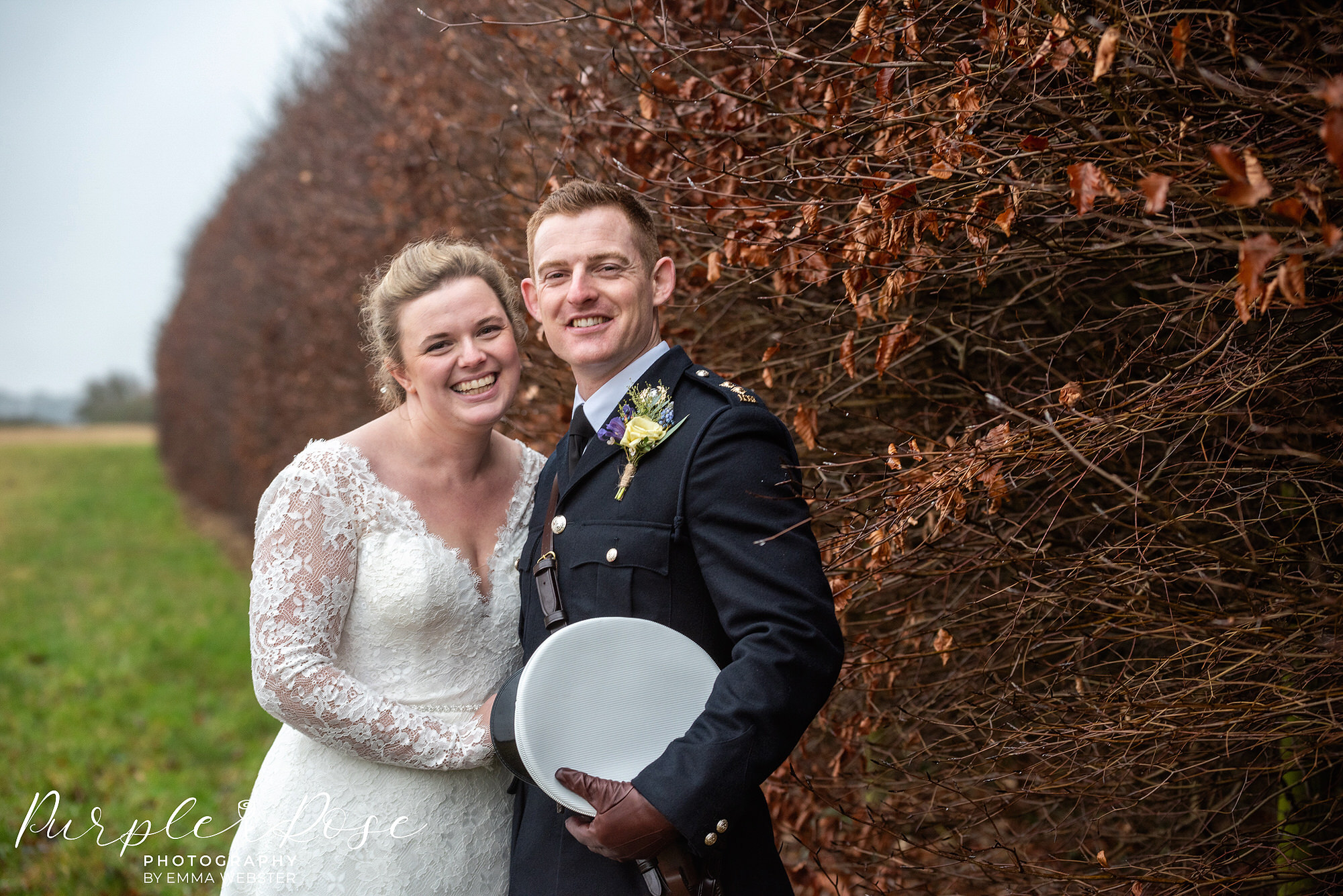 Photograph of a bride a bride and groom smiling on their wedding day