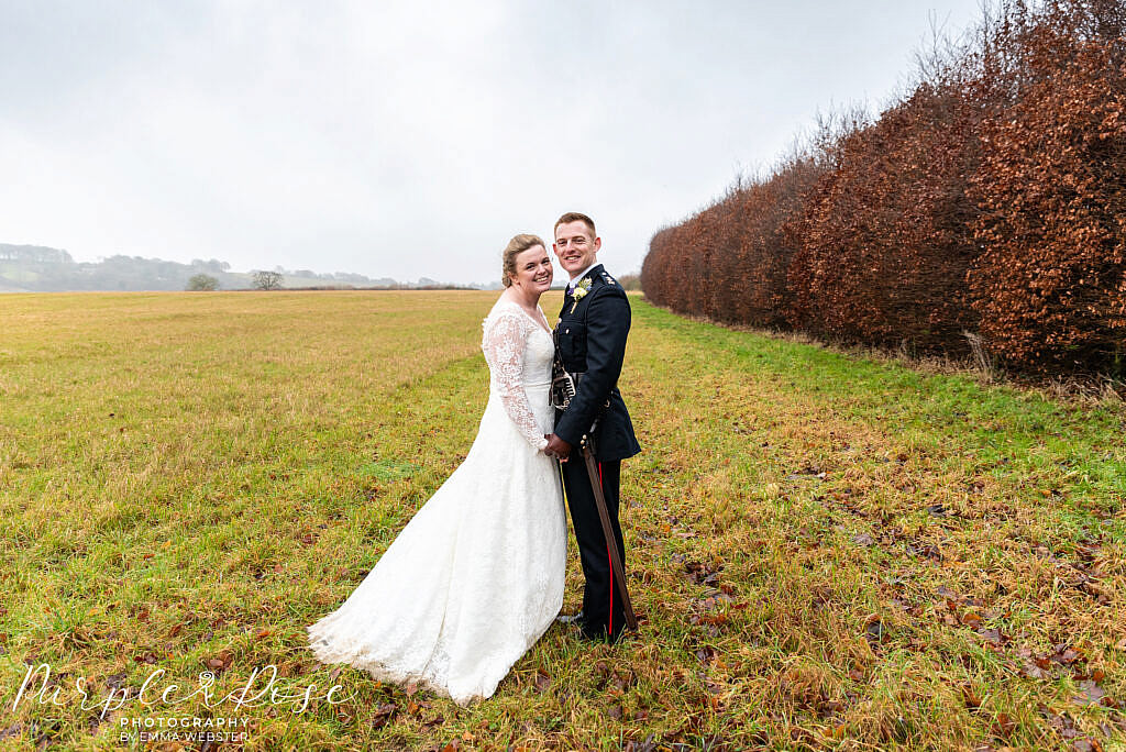 bride and groom in a misty field