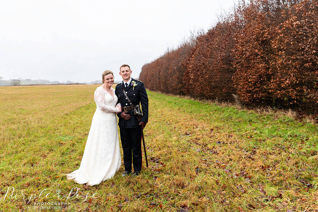 Bride and groom in a field