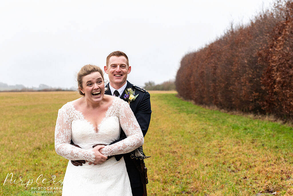 Bride laughing with her groom