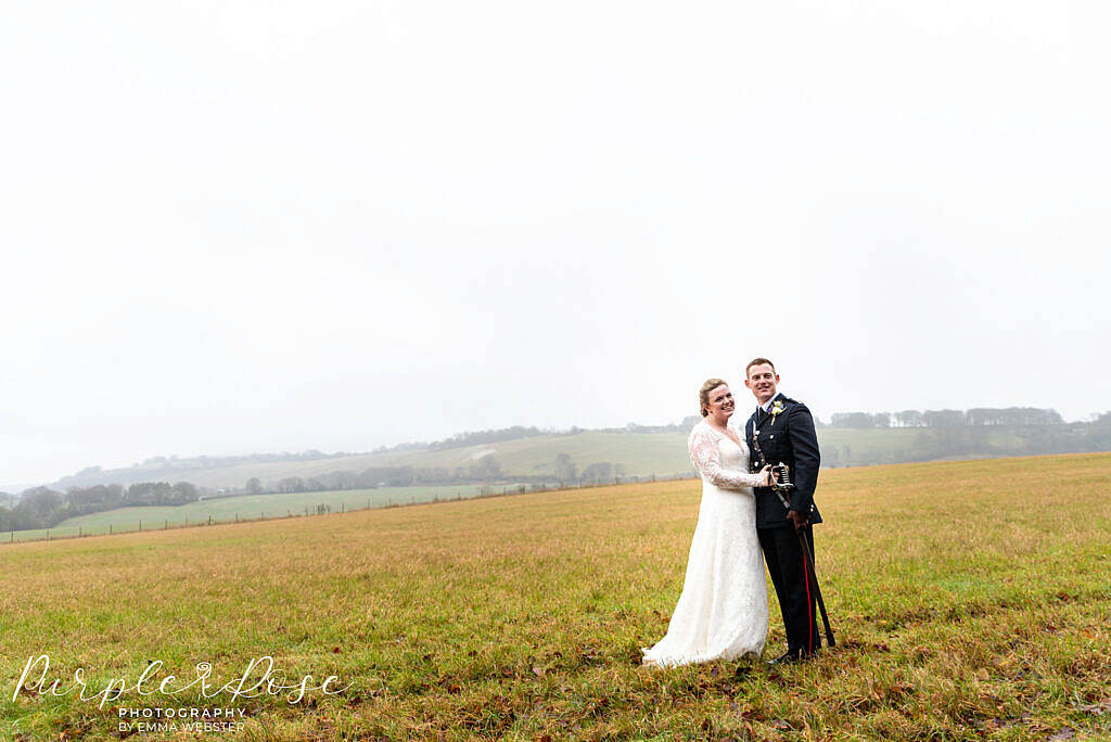 bride and groom in a field on their wedding day