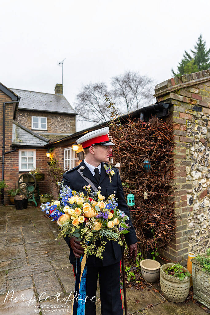 Groom holding the bride bouquet