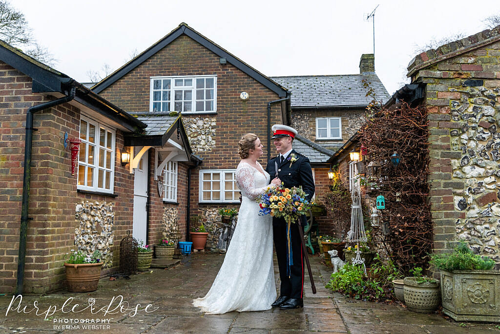 Bride and groom standing in a courtyard
