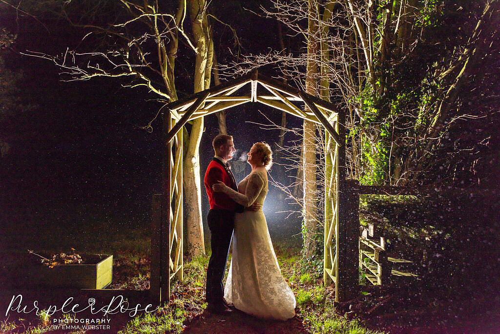 Bride and groom in an archway