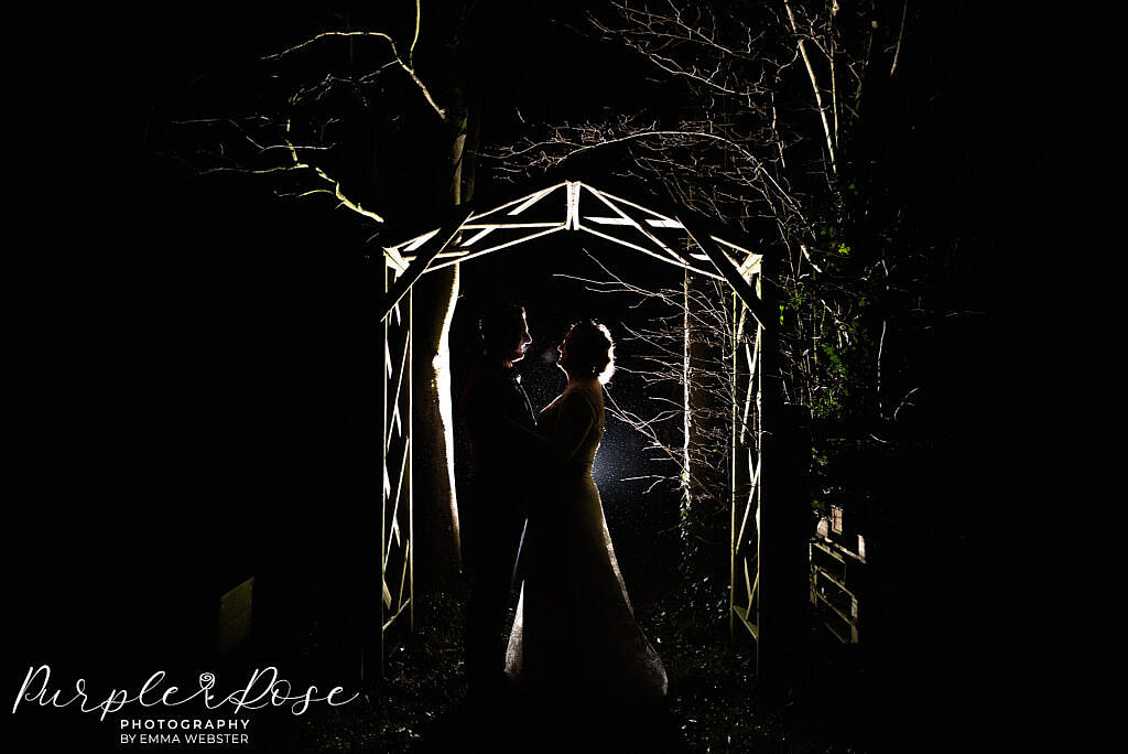 Bride and groom under an archway