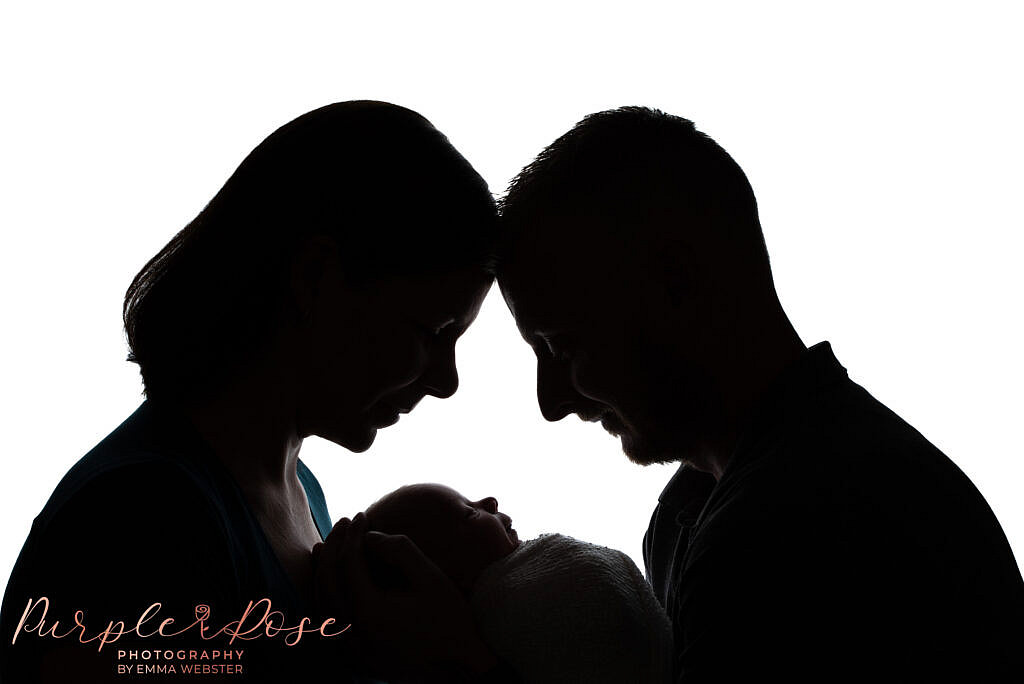 Silhouette of mum, dad and baby