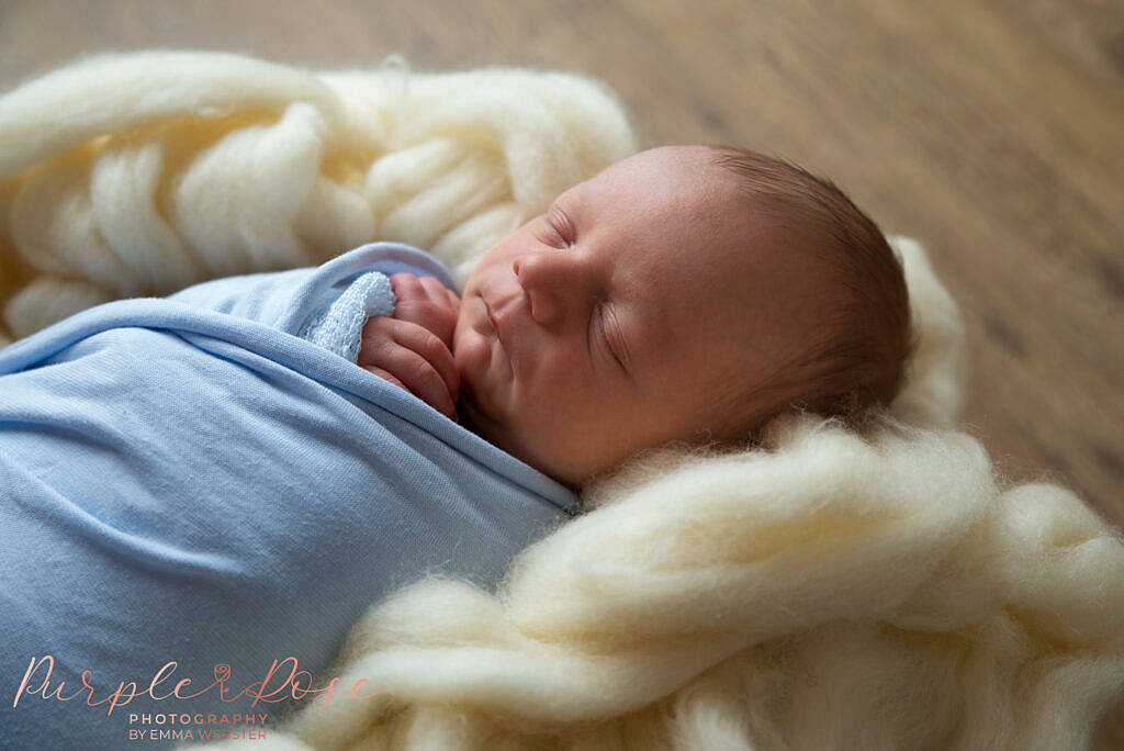 Newborn baby sleeping on fluffy layer