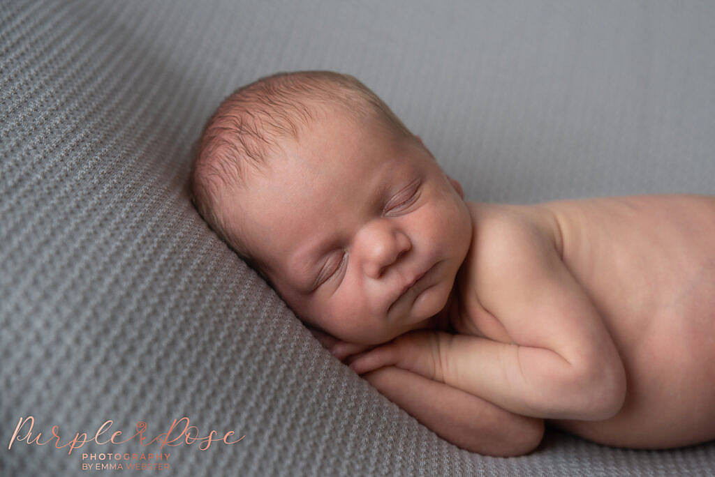 Newborn baby boy fast asleep at his photo shoot in Milton Keynes