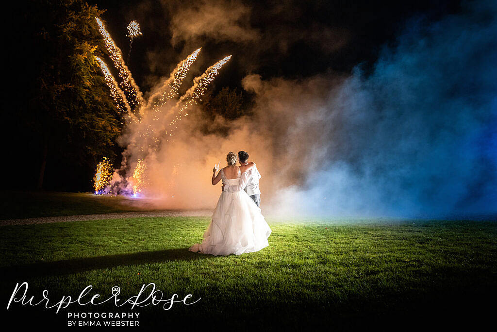 Bride and groom watching fire works