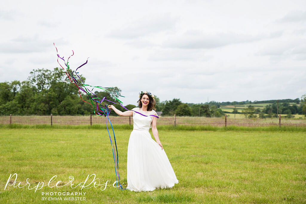 bride laughing in a field