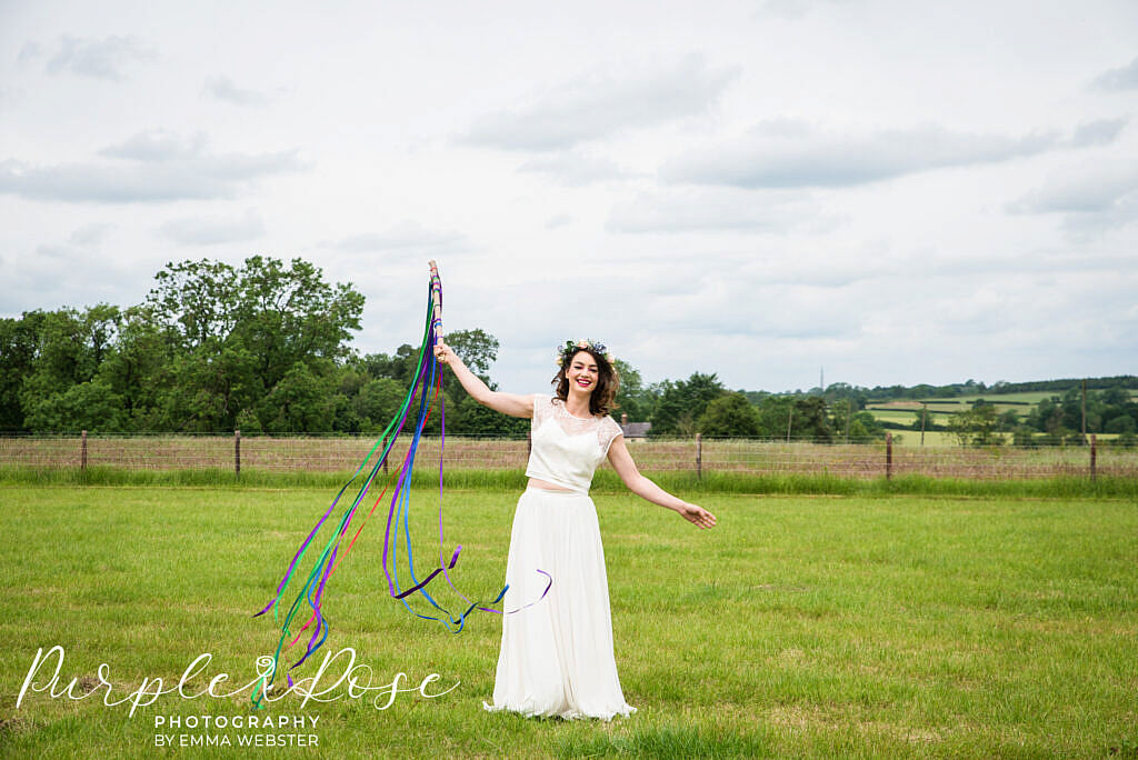 Bride in a field giggeling