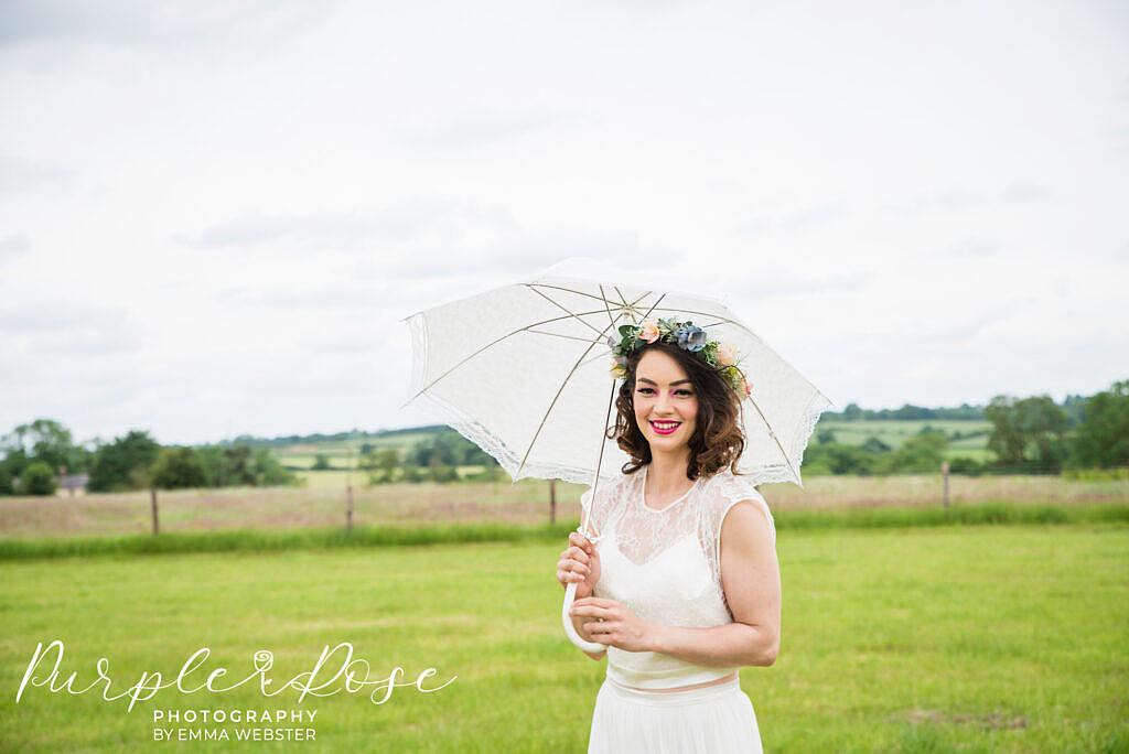 Bride standing under an umbrella