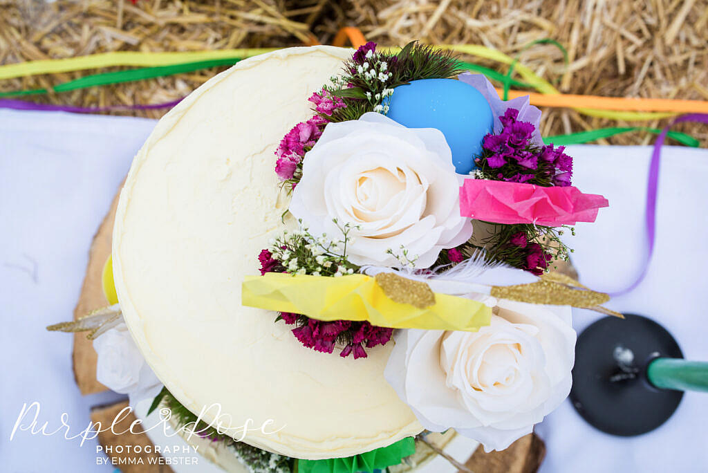 Cake decorated with balloons and flowers