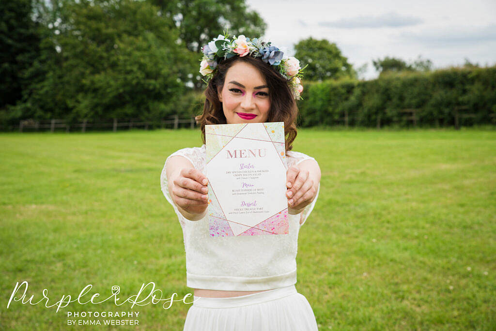 bride smiling while holding a menu