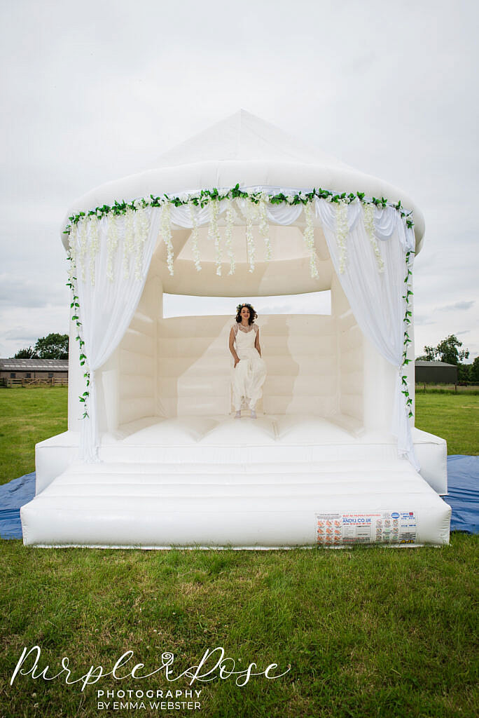 bride jumping on a bouncy castle