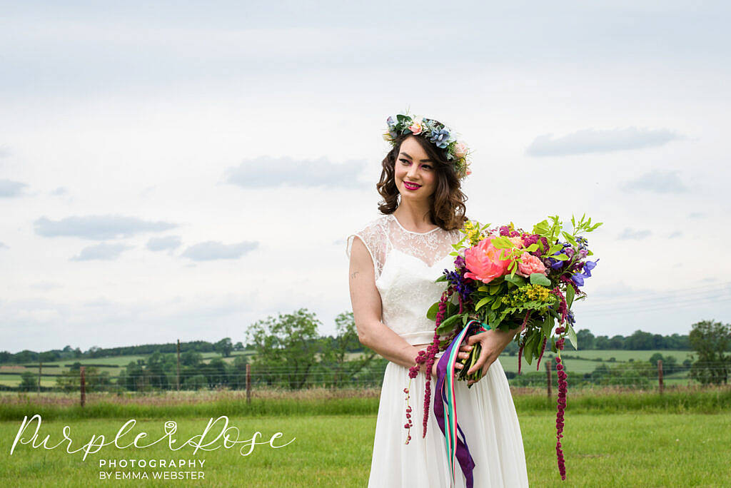 bride standing with her wedding flowers