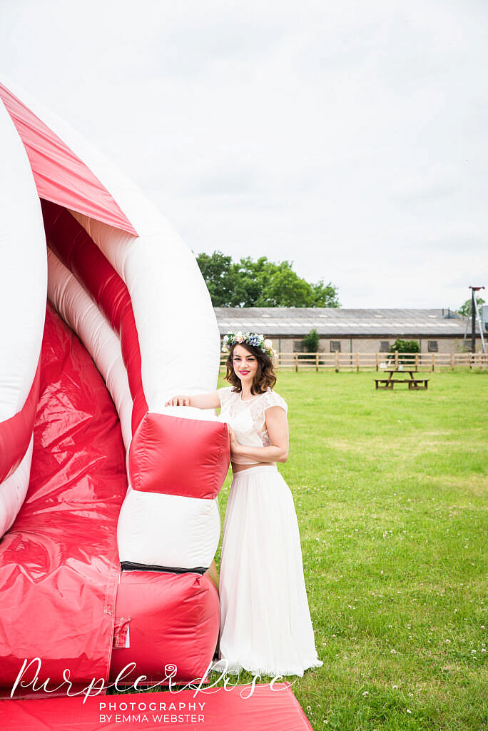 bride leaning on a bouncy castle