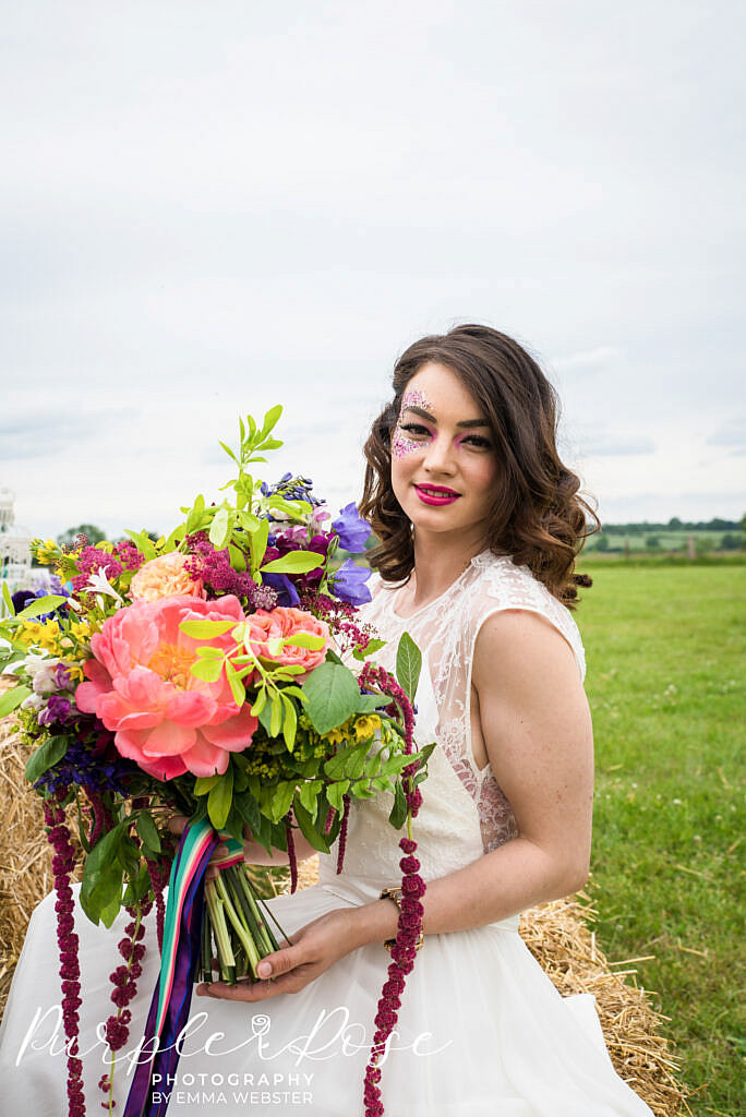 Bride sitting in a field
