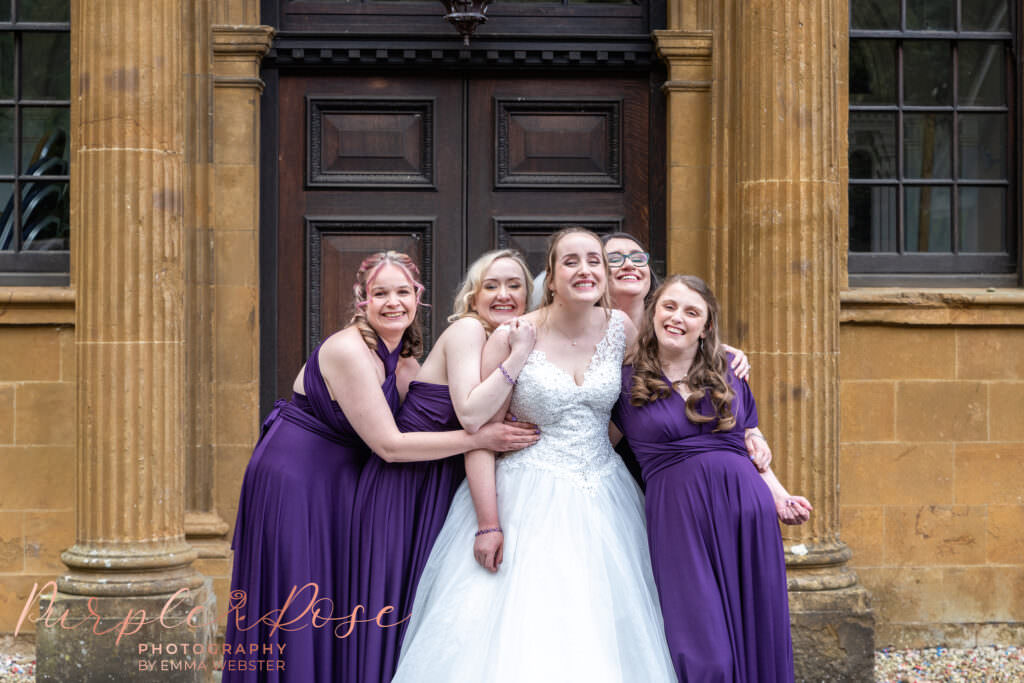 Bride laughing with her bridesmaids