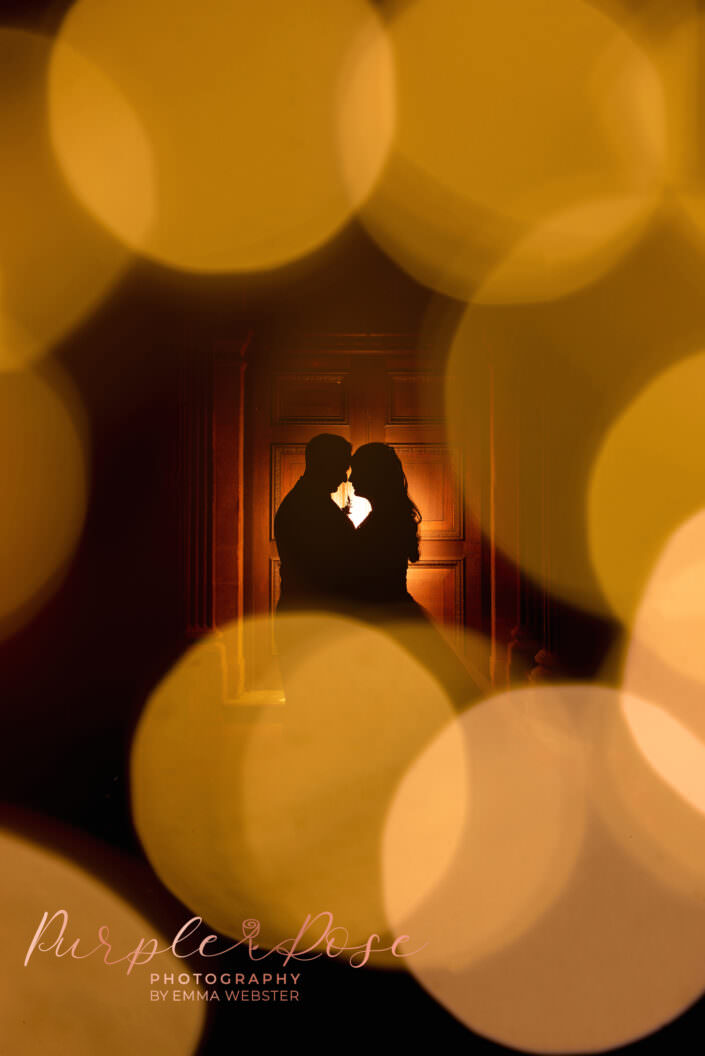 Silhouette of a bride and groom surrounded by balls of light