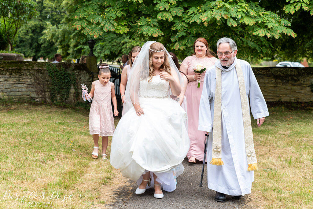 Bridal party walking to the church