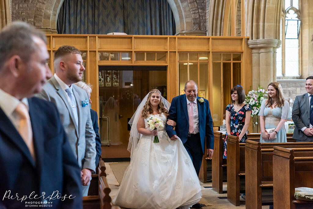 Bride and her father walking into the church