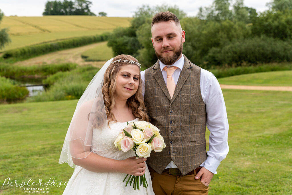 Bride and groom in front of rolling fields