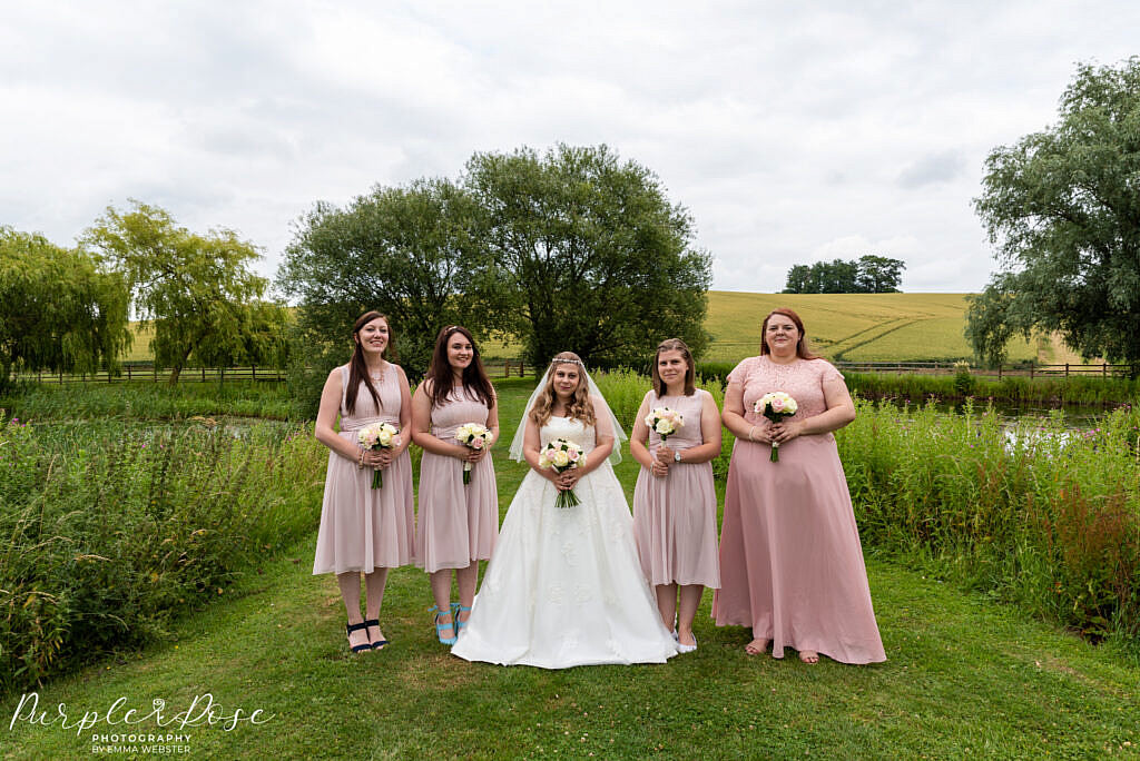 Bride posing with her bridesmaids