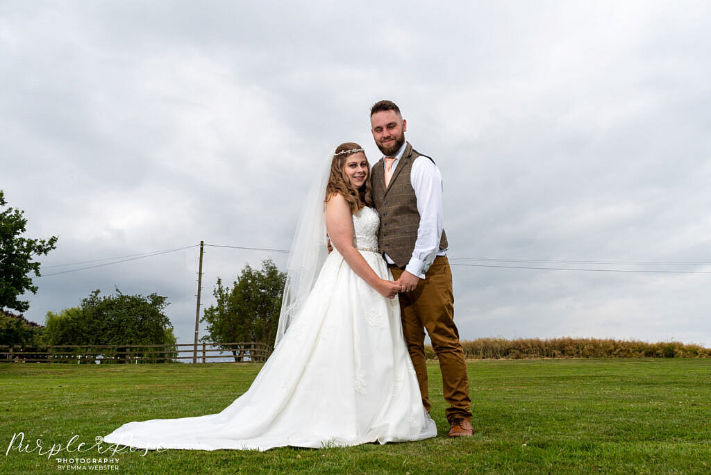 Couple posing in gardens at Newton Park Farm