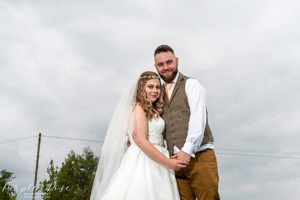 Bride & Groom posing in gardens at Newton Park Farm