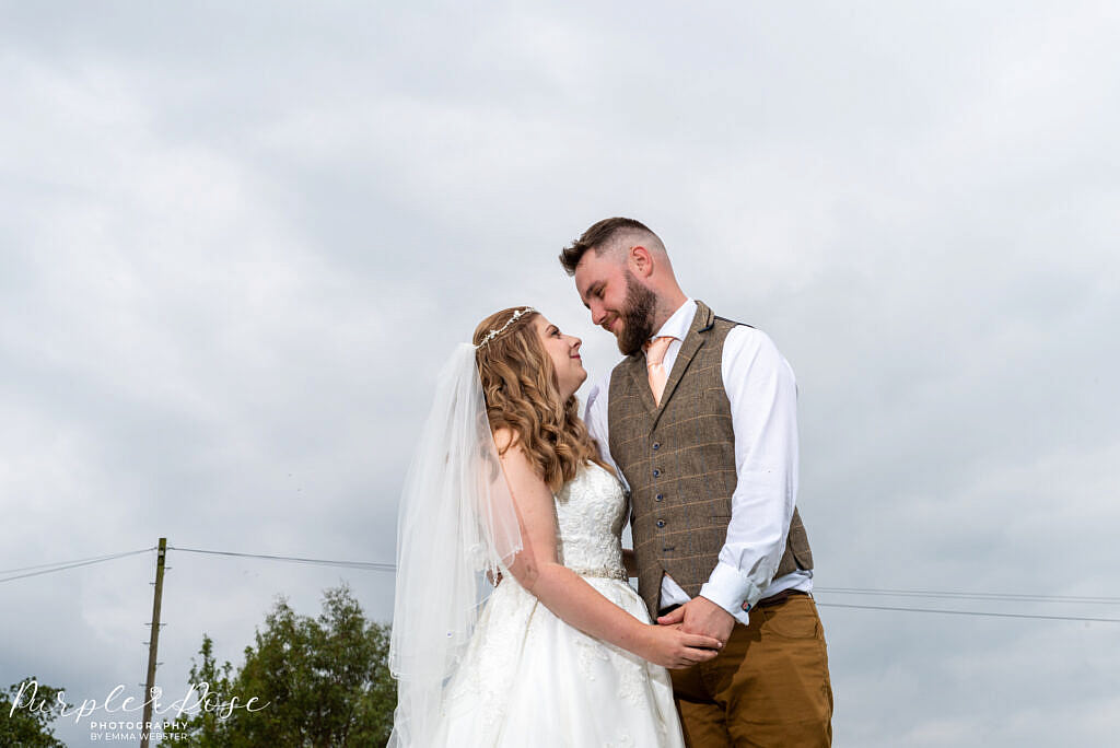 bride and Groom posing in gardens at Newton Park Farm