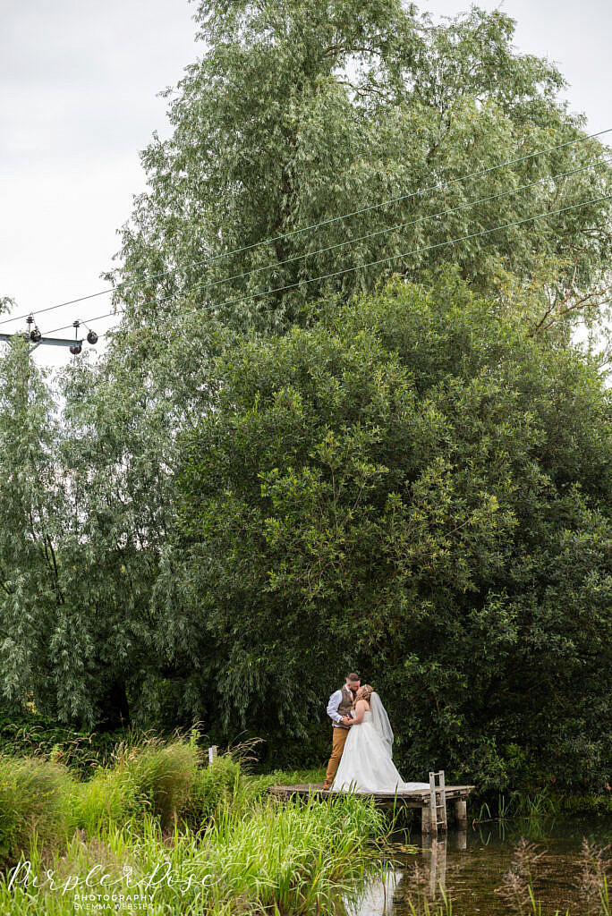 Bride and groom by a lake